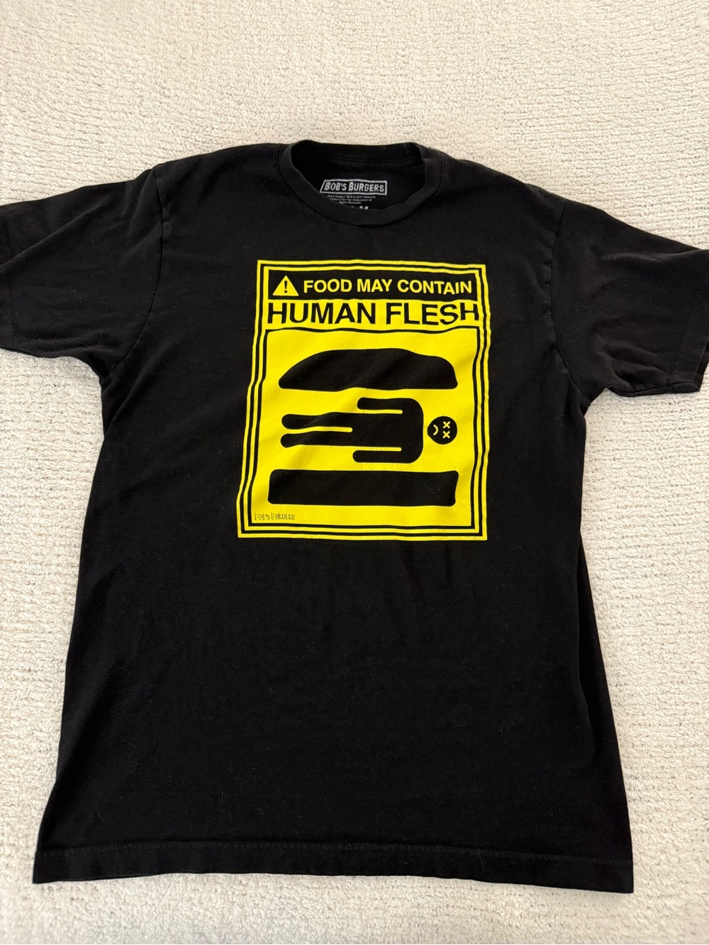 Bob’s Burgers “Food May Contain Human Flesh" Black Graphic Tee